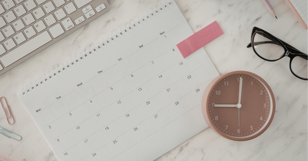 desk with calendar and clock on it